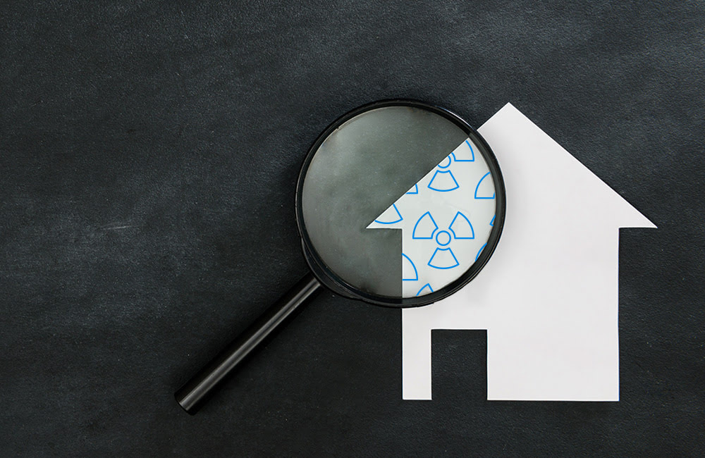 magnifying glass revealing unseen radon in a home